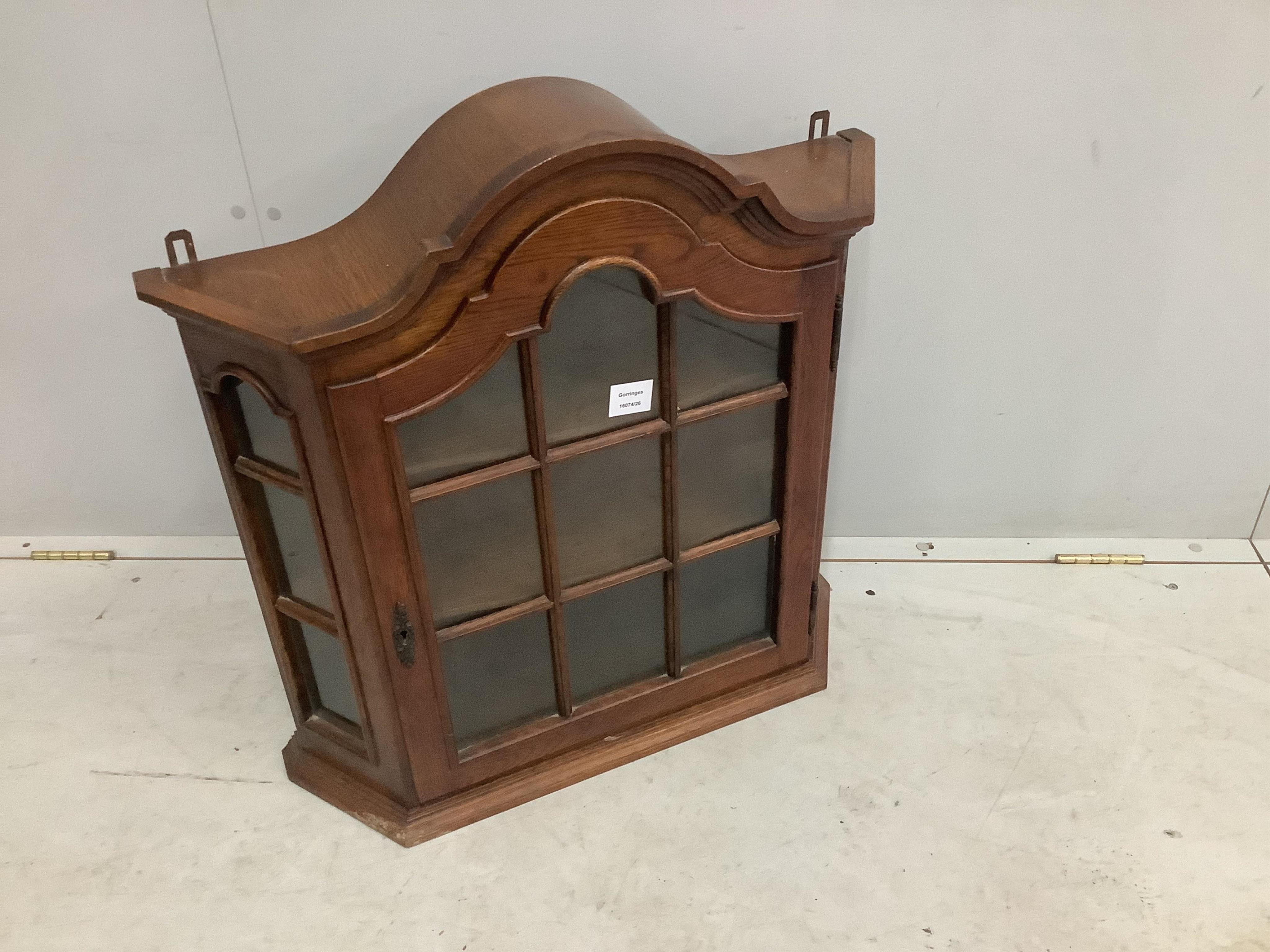 An 18th century style Dutch oak hanging wall cabinet, width 68cm, height 61cm. Condition - good